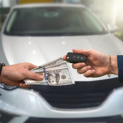 the seller of a luxury car dealership gives the owner the car keys and the other pays for the dollars. The concept of buying a car